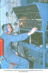 Aerial photographer at photo panel of RC-130A during mapping mission for AST-10